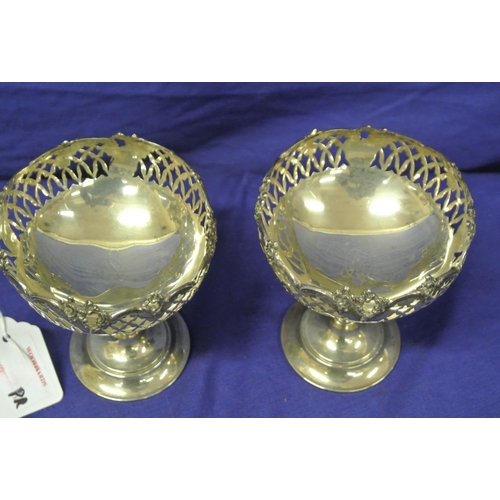 65 - Pair of Birmingham silver stemmed vases with pierced and foliate decoration, on round bases 163g, 11... 