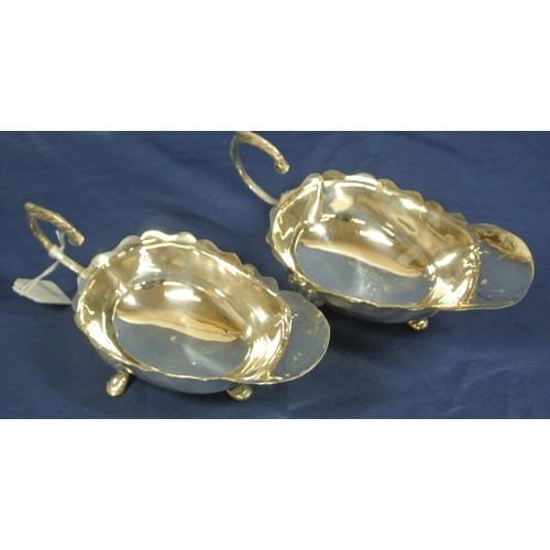 15 - Pair of boat shaped silver plated sauce or gravy boats with wavy rims and scroll handles