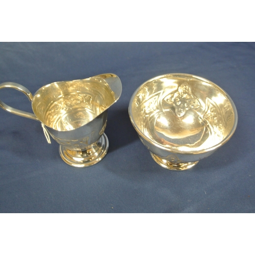 183 - Irish silver creamer and sugar bowl with Celtic decorated panels, on round spreading bases, by Bee M... 