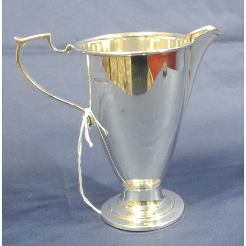 237 - Irish silver cream jug of round tapering form with wire rim, capped shaped handle, on round stepped ... 