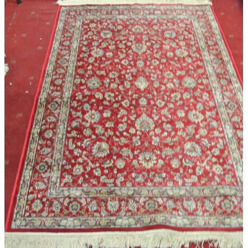 132 - Red ground full pile Kashmir rug with all over floral pattern 220 x130 cm