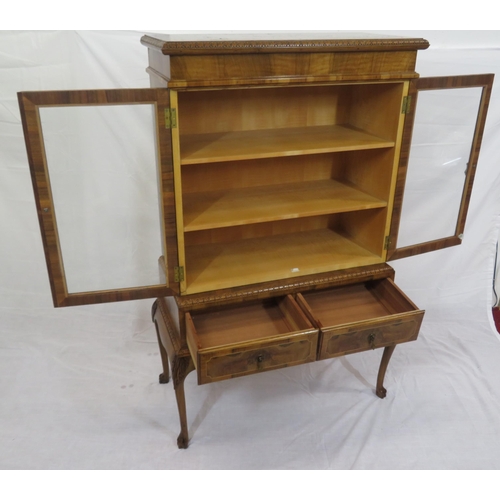 140 - Edwardian design walnut bookcase with foliate decoration, glazed doors, shelved interior, two drawer... 