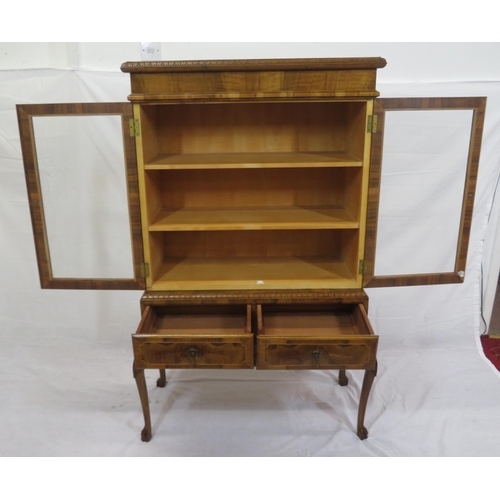 140 - Edwardian design walnut bookcase with foliate decoration, glazed doors, shelved interior, two drawer... 