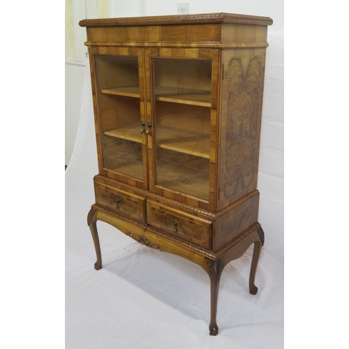 140 - Edwardian design walnut bookcase with foliate decoration, glazed doors, shelved interior, two drawer... 