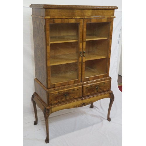 140 - Edwardian design walnut bookcase with foliate decoration, glazed doors, shelved interior, two drawer... 