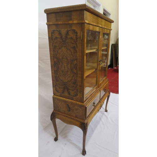 140 - Edwardian design walnut bookcase with foliate decoration, glazed doors, shelved interior, two drawer... 