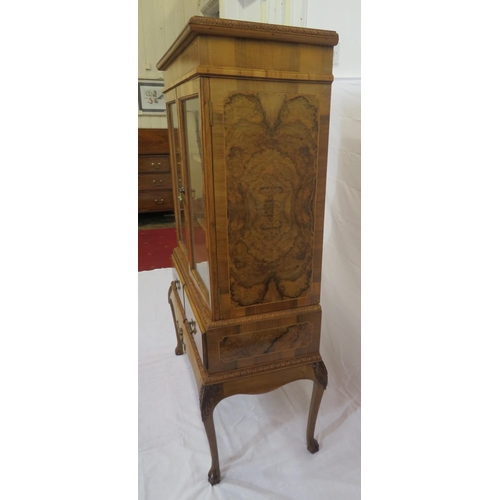 140 - Edwardian design walnut bookcase with foliate decoration, glazed doors, shelved interior, two drawer... 