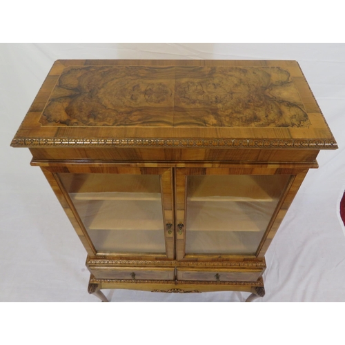 140 - Edwardian design walnut bookcase with foliate decoration, glazed doors, shelved interior, two drawer... 