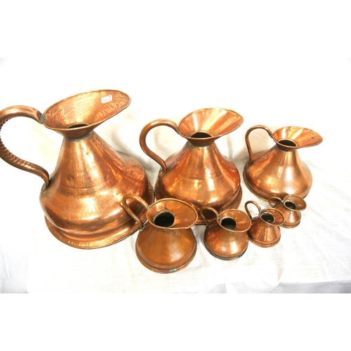 148 - Set of 7 copper measures with shaped handles