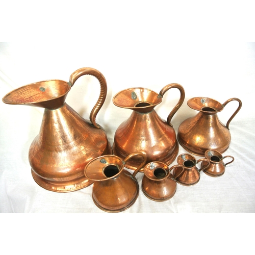 148 - Set of 7 copper measures with shaped handles