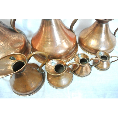 148 - Set of 7 copper measures with shaped handles