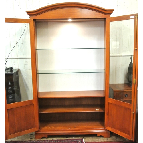 155 - Yew bookcase or display cabinet with serpentine top, glazed doors and shelving, on bracket feet