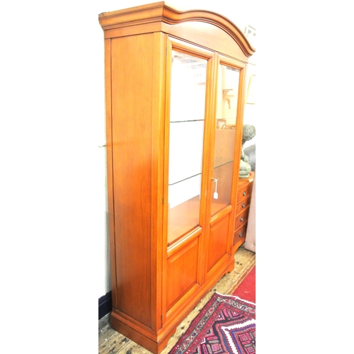 155 - Yew bookcase or display cabinet with serpentine top, glazed doors and shelving, on bracket feet