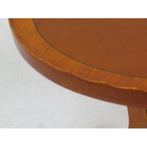 196 - Oval inlaid yew occasional table with wavy rim, turned column, on reeded shaped legs