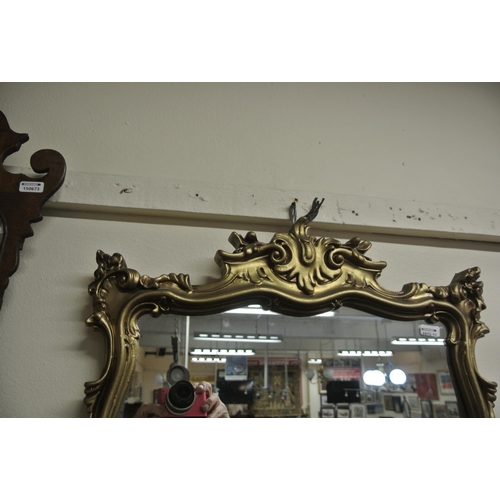 229 - Regency design gilt framed shaped mirror with scroll and foliate decoration