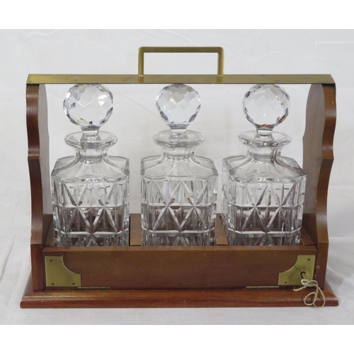 233 - Edwardian brass and mahogany tantalus with 3 decanters, locking drop down front