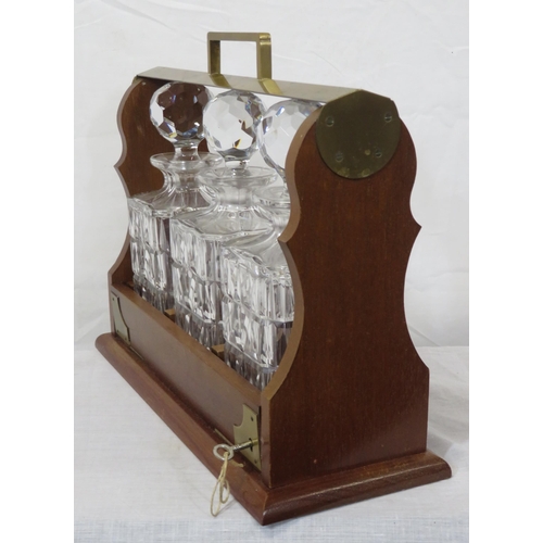 233 - Edwardian brass and mahogany tantalus with 3 decanters, locking drop down front