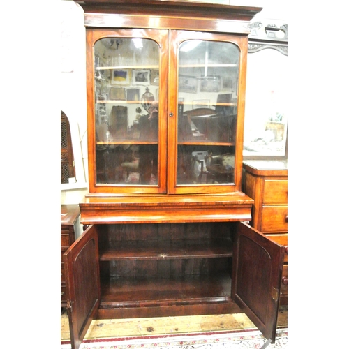 305 - Victorian mahogany bookcase with glazed doors, shelving, drawer, press under, on plinth