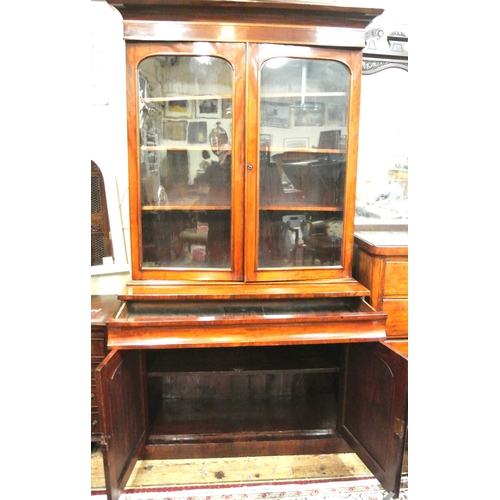 305 - Victorian mahogany bookcase with glazed doors, shelving, drawer, press under, on plinth