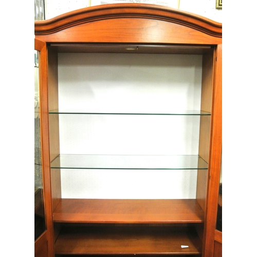 80 - Yew bookcase or display cabinet with serpentine top, glazed doors and shelving, on bracket feet