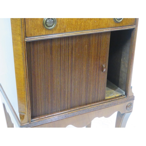 101 - Edwardian mahogany cabinet with frieze drawer, drop handles, press with tambour front, on shaped inl... 