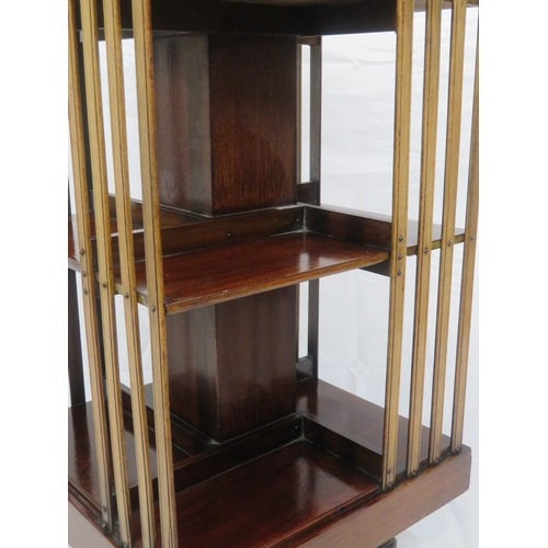 109 - Edwardian mahogany revolving bookcase with railed sides, on castors