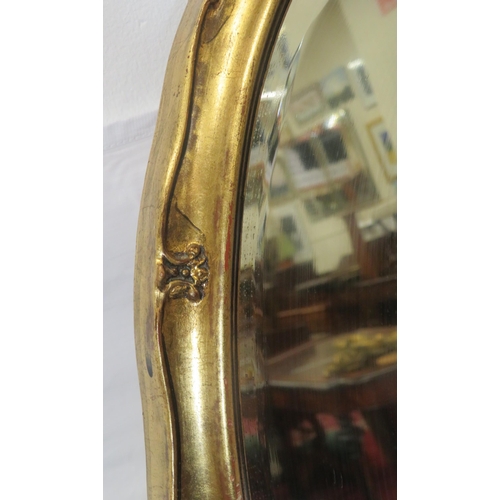 188 - Oval framed bevelled glass wall mirror with ornate gilt frame