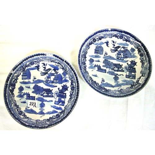 223 - Pair of Oriental style willow pattern round dishes with ornate scenic blue & white decoration