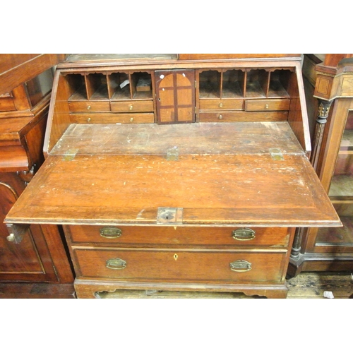 230 - Georgian crossbanded oak bureau bookcase, the top with panelled doors & shelved interior, drop-down ... 