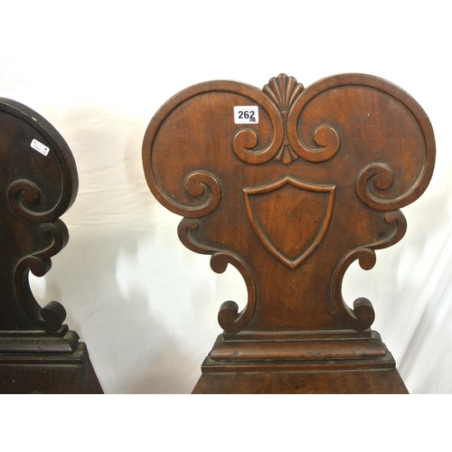 262 - Pair of Victorian mahogany hall chairs with scroll shield shaped decorated backs, bow fronted seats,... 