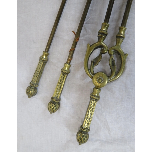 72 - Set of 3 Victorian style brass fire implements with ornate pierced handles and a pair of brass rests