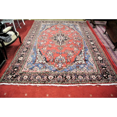 257 - Washed red ground full pile Persian Sarouk carpet with medallion design 340 x240