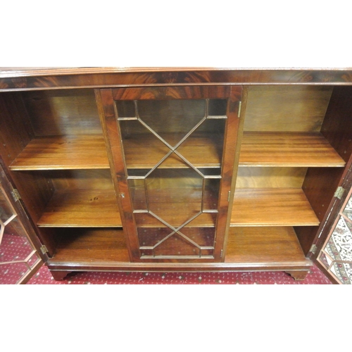 105 - Edwardian style triple bookcase with astragal glazed doors, shelved interior, on bracket feet