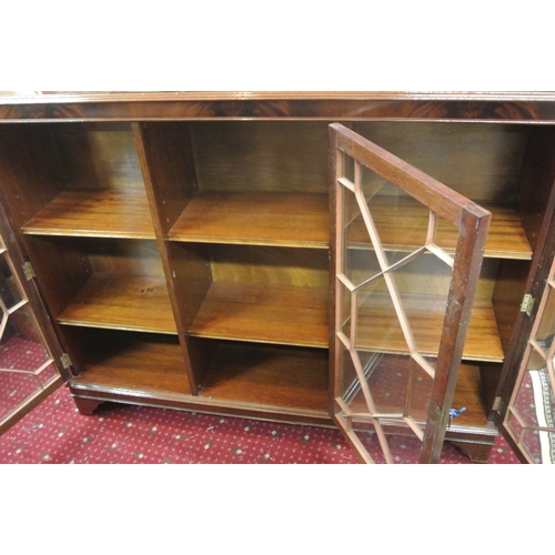 105 - Edwardian style triple bookcase with astragal glazed doors, shelved interior, on bracket feet