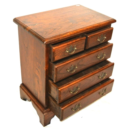 129 - Small oak chest of two short & three long drawers with drop handles, & bracket feet