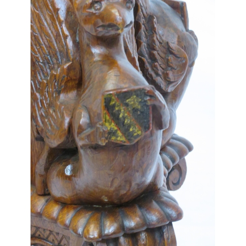 173 - Pugin style brass & timber garment stand with adjustable top, carved gargoyles with shields, on shap... 