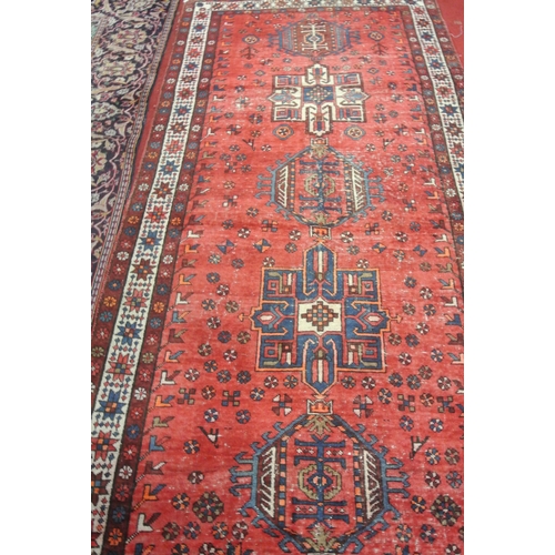 187 - Washed red ground vintage Persian Heriz runner with medallion design 325 x 120cm