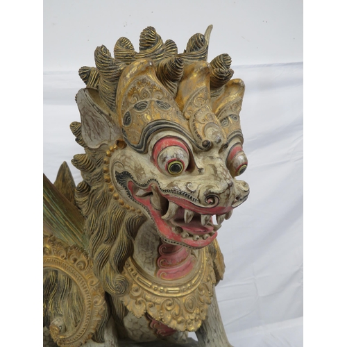 188 - Oriental carved timber temple dragon, ornately carved & with painted decoration, on shaped base