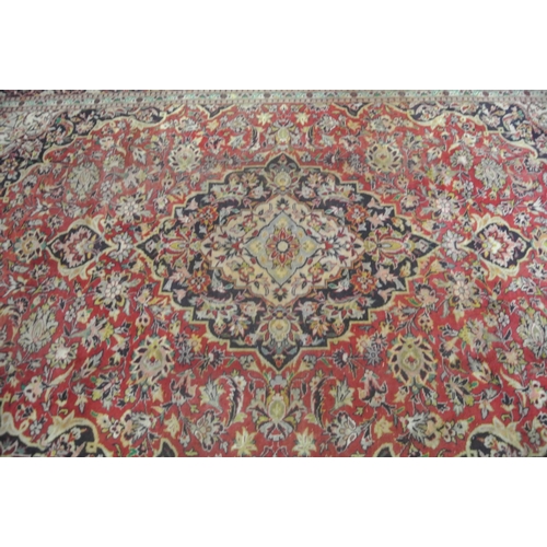242 - Red ground Persian Kashan carpet with floral medallion design 333x225