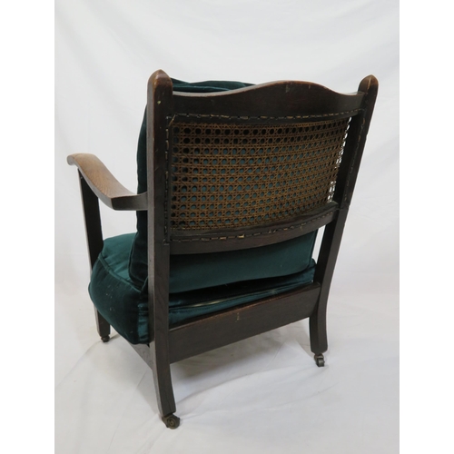 385 - Oak Arts & Crafts style open armchair with wicker back, upholstered seat, on tapering legs