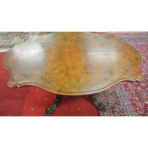 200 - Victorian walnut centre or library table with serpentine shaped sides, raised on ornate carved shape... 