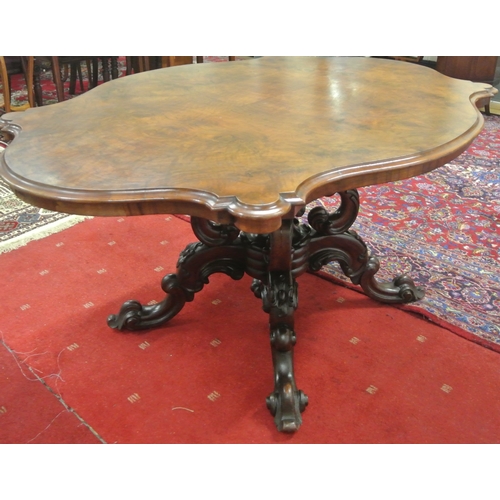 200 - Victorian walnut centre or library table with serpentine shaped sides, raised on ornate carved shape... 