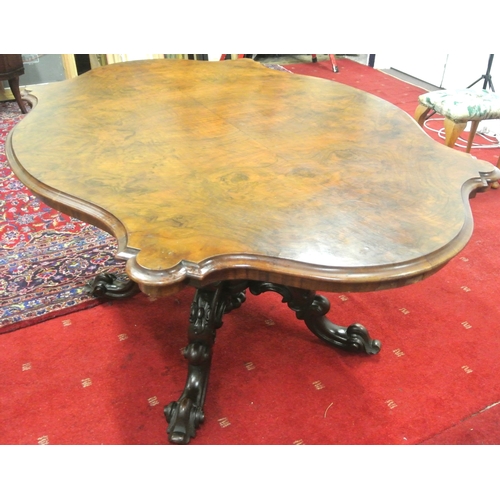 200 - Victorian walnut centre or library table with serpentine shaped sides, raised on ornate carved shape... 