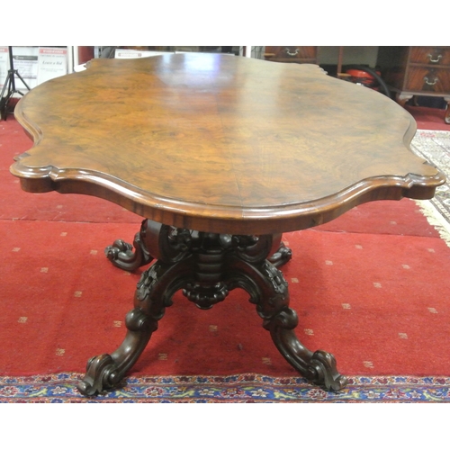 200 - Victorian walnut centre or library table with serpentine shaped sides, raised on ornate carved shape... 