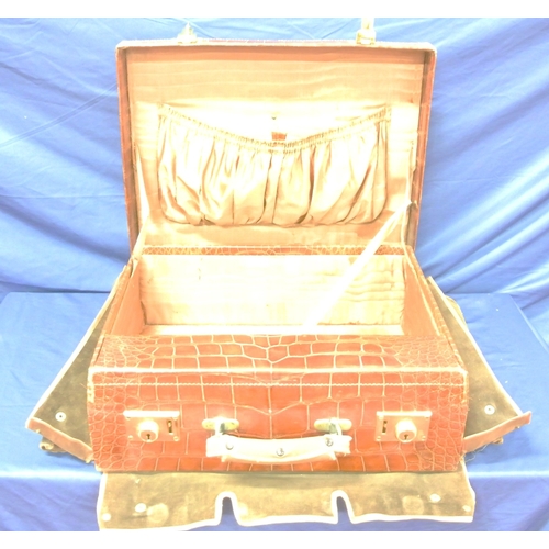 102 - Vintage crocodile lined travel suitcase with silver topped brushes and bottles inset