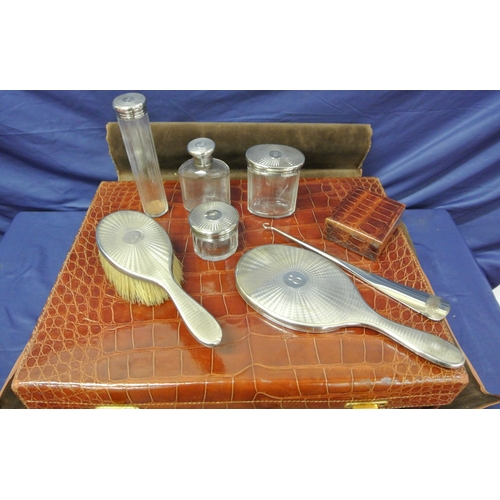 102 - Vintage crocodile lined travel suitcase with silver topped brushes and bottles inset