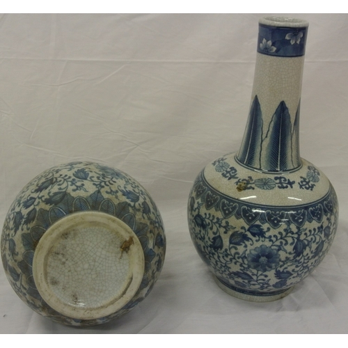 153 - Pair of Oriental style long necked ginger jars with ornate blue & white foliate decoration