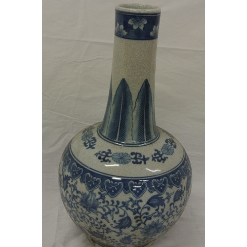 153 - Pair of Oriental style long necked ginger jars with ornate blue & white foliate decoration