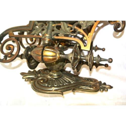 172 - Pair of vintage bronze wall lights, with folding shaped arms, finials, foliate decoration & scroll b... 