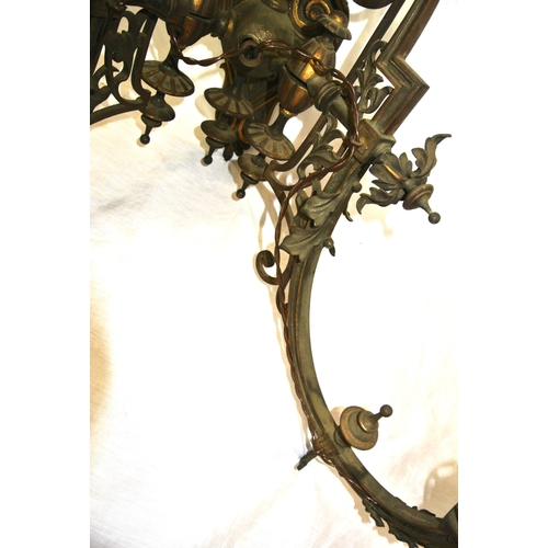 173 - Pair of vintage bronze wall lights, folding shaped arms, finials, foliate decoration, scroll backpla... 